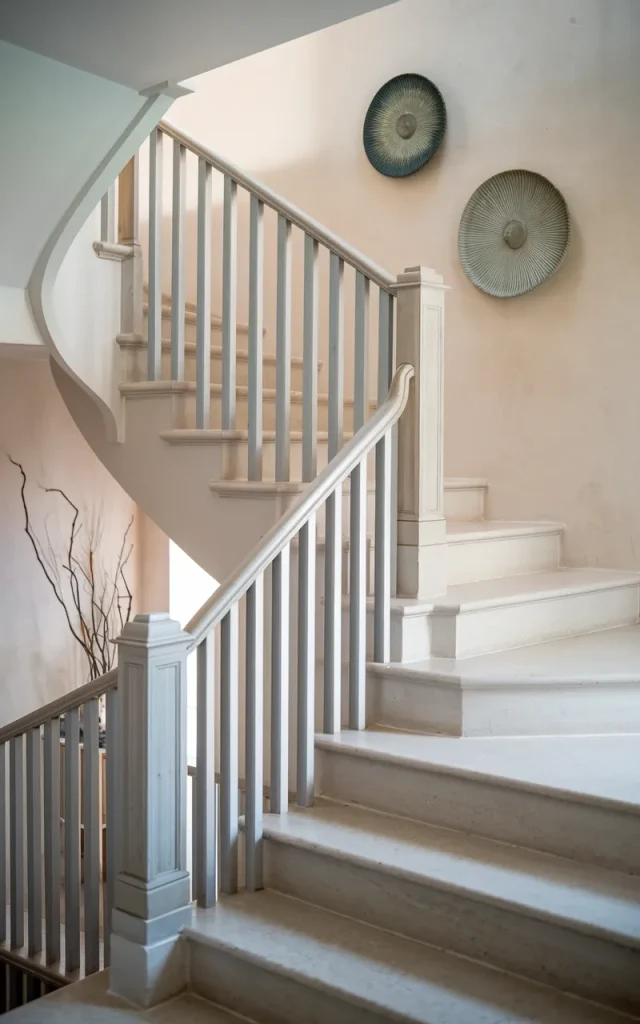 Keep the staircase intentionally minimal and uncluttered