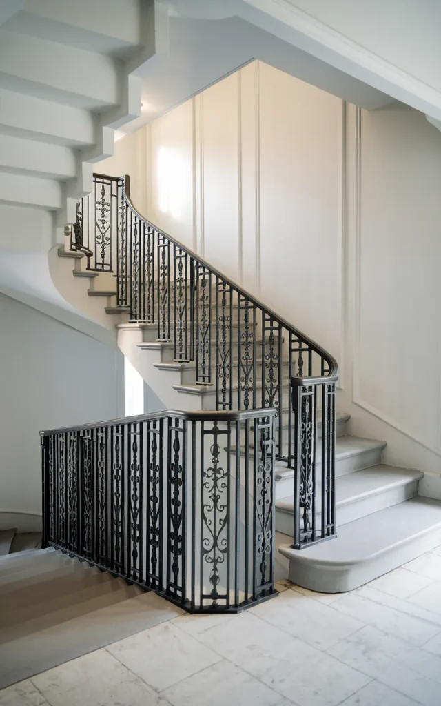 Paint your wrought iron staircase matte black for bold contrast